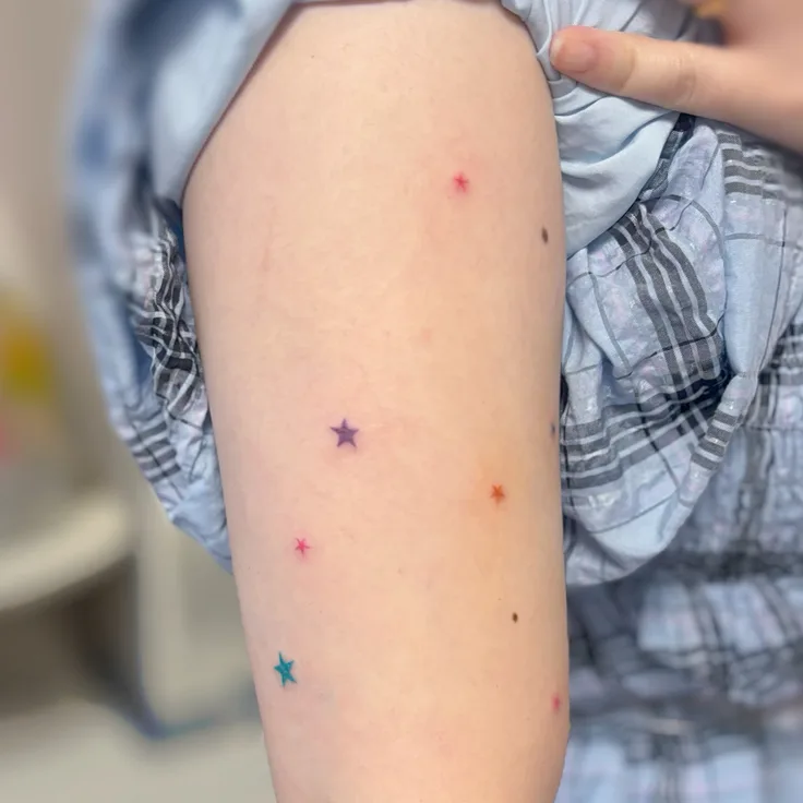 両腕の小さなカラフルな星
